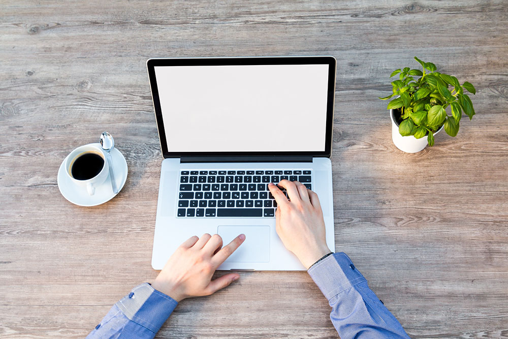 Freelancer at his desk using a laptop
