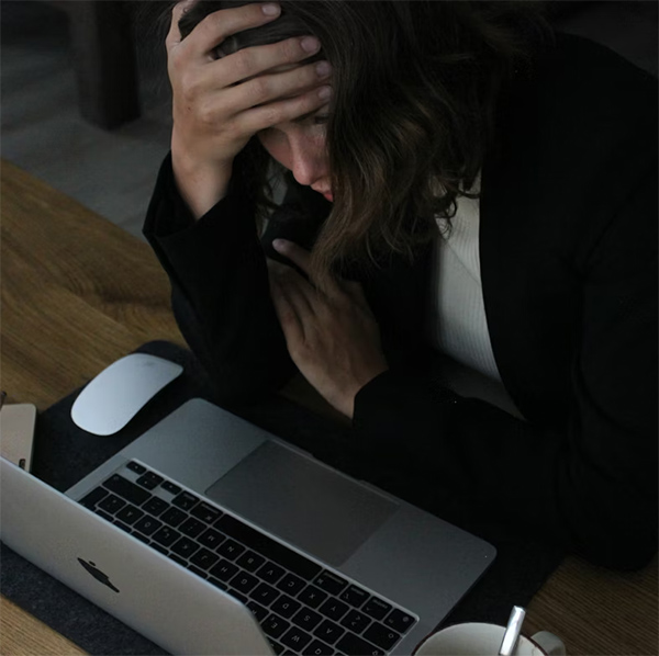 Online store owner stressed using her laptop